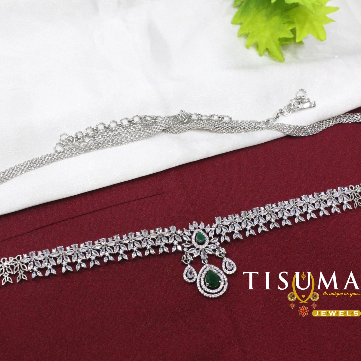 Silver-tone bridal hip belt with floral AD-style stones and a green centre pendant