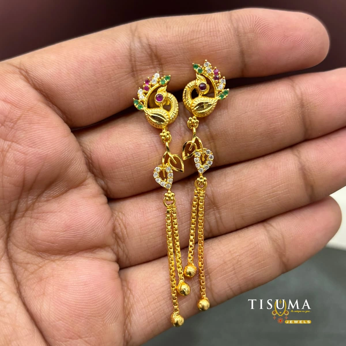 Gold-tone peacock design long drop earrings with green ruby and white stones