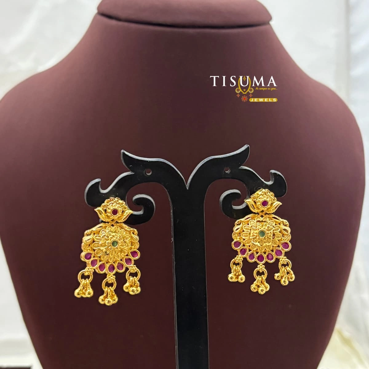 Gold-tone floral drop earrings with ruby-pink and green stones