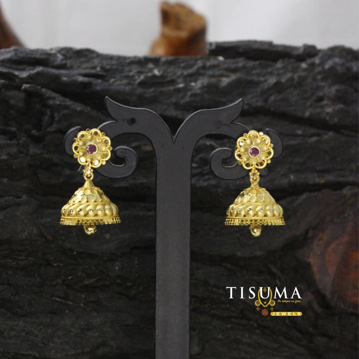 Gold-tone floral stud jhumka earrings with ruby-pink centre stones