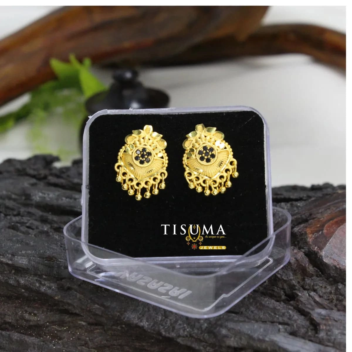 Gold-tone floral drop earrings with black stone centre and dangling bead charms