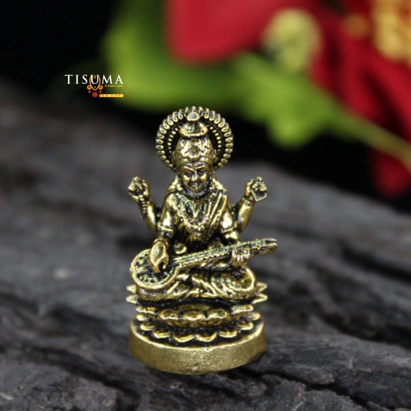 Antique gold-finish Goddess Saraswati idol seated with a veena and decorative halo