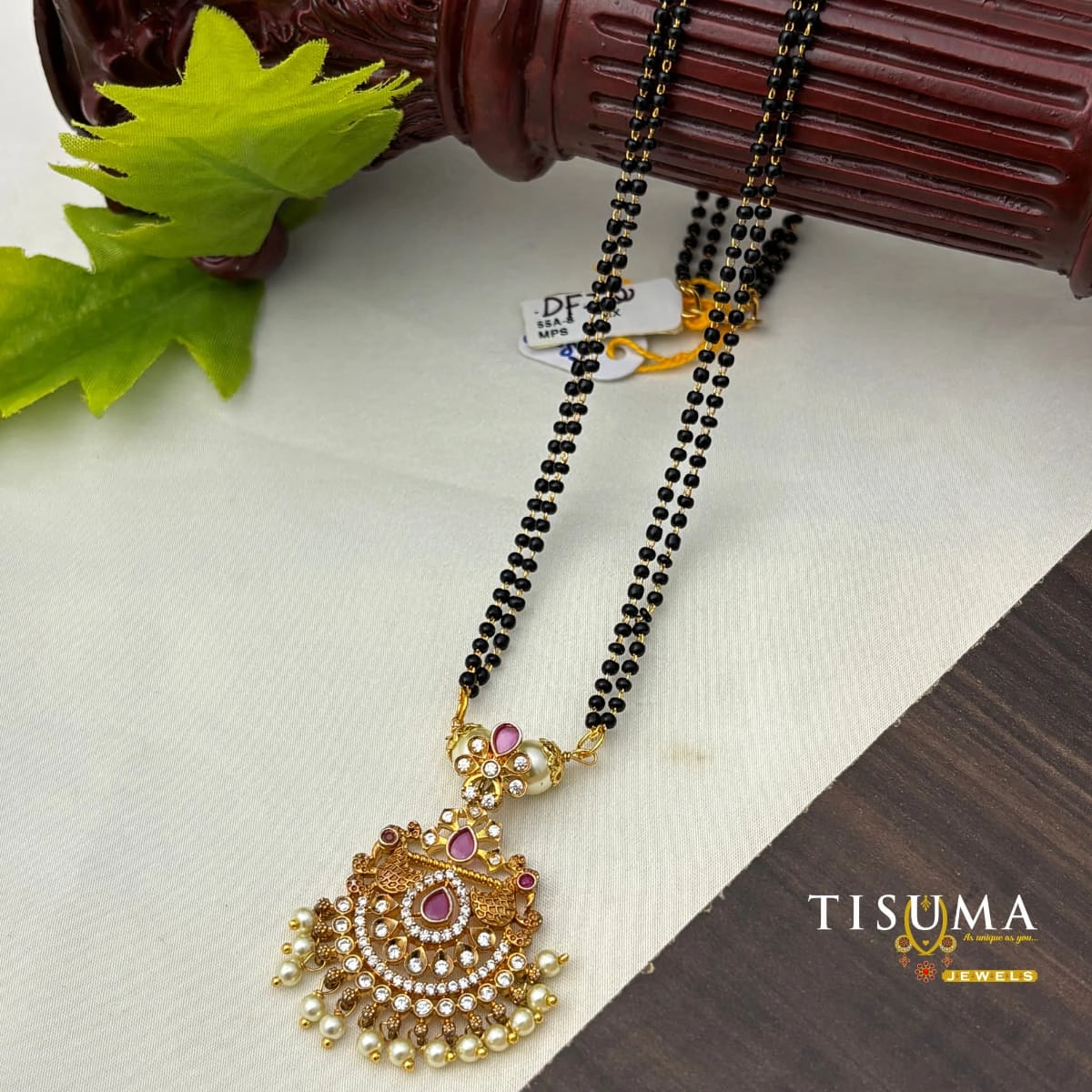 Antique gold-finish black beads mangal sutra with pink stones and pearl-drop pendant