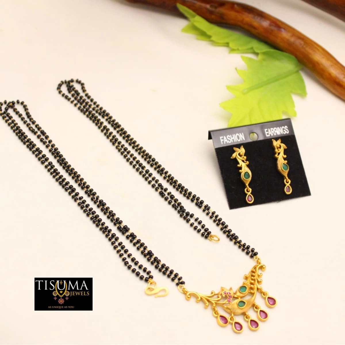 Black beads mangal sutra with gold-finish pendant and pink green stone accents