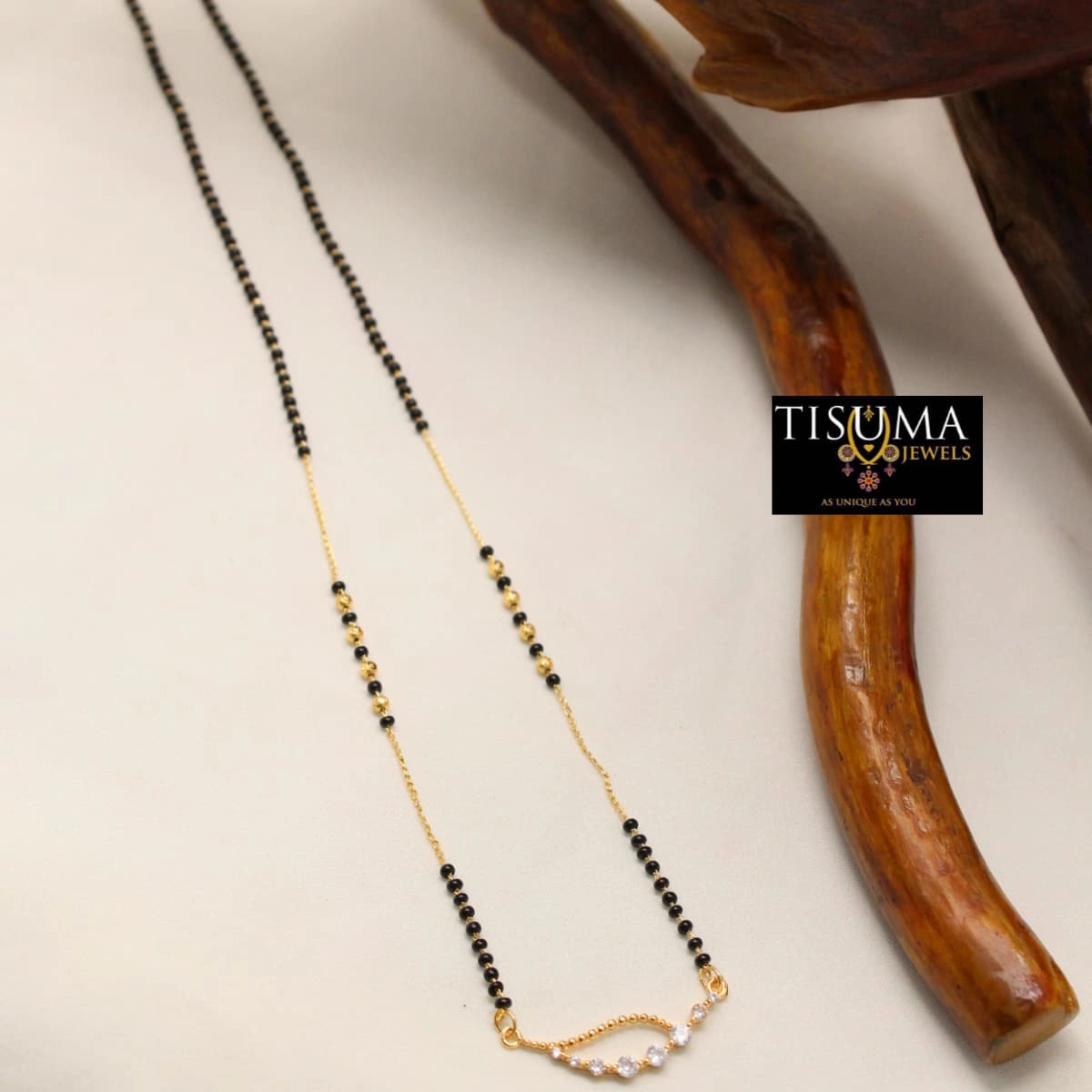 Black beads mangal sutra with gold-finish chain and white stone detailing