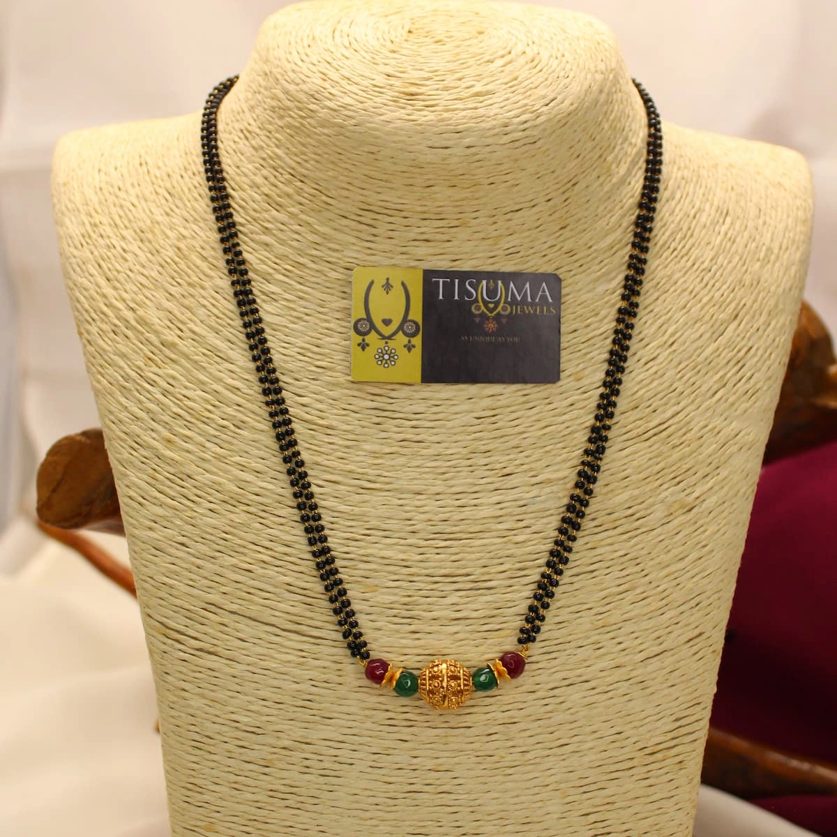 Double-line black beads mangal sutra with gold-tone centre bead and red green accents