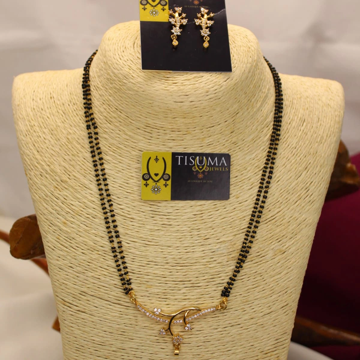 Double-line black beads mangal sutra with gold-tone wave pendant and white AD stones