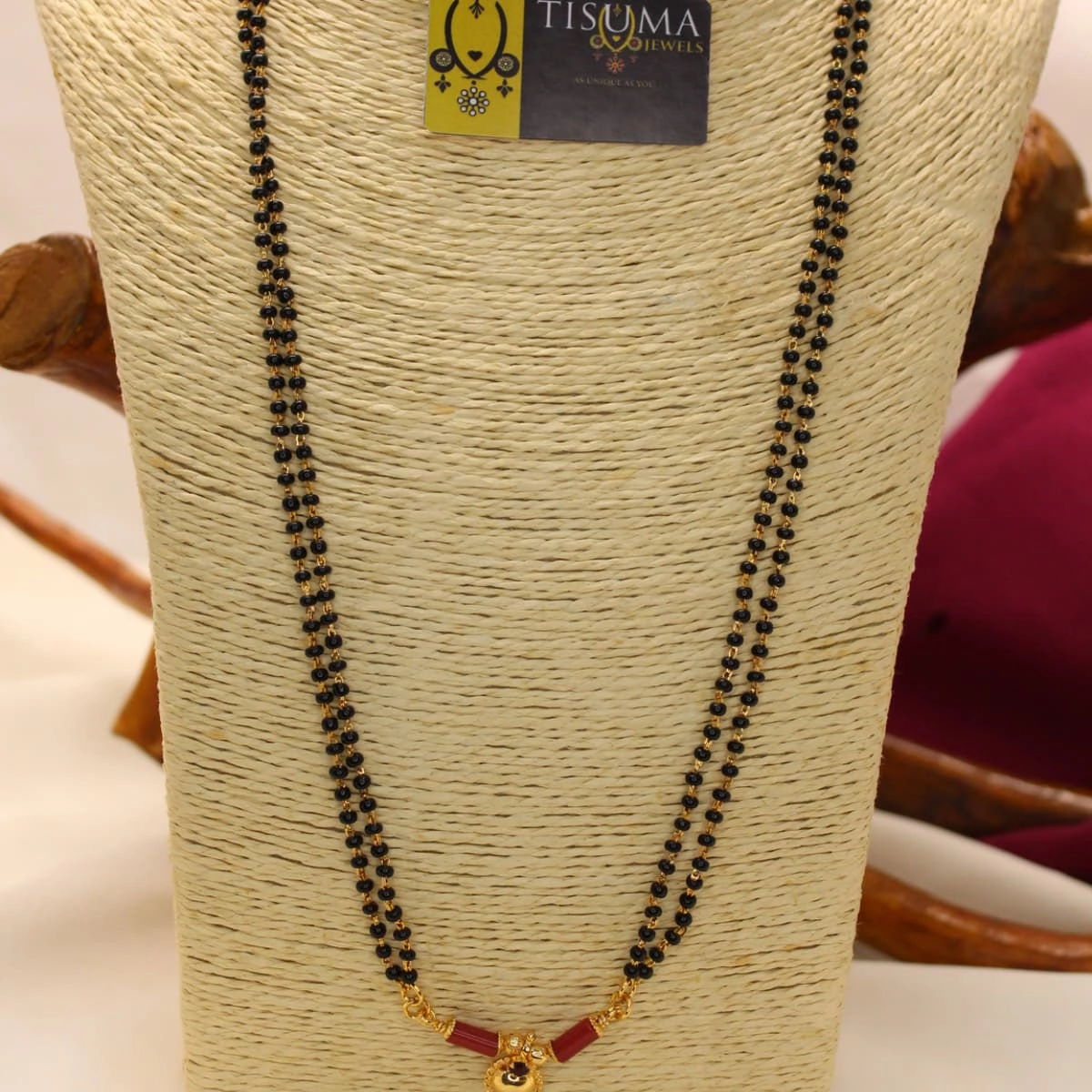 Double-line black beads mangal sutra with red accent beads and gold-tone detailing