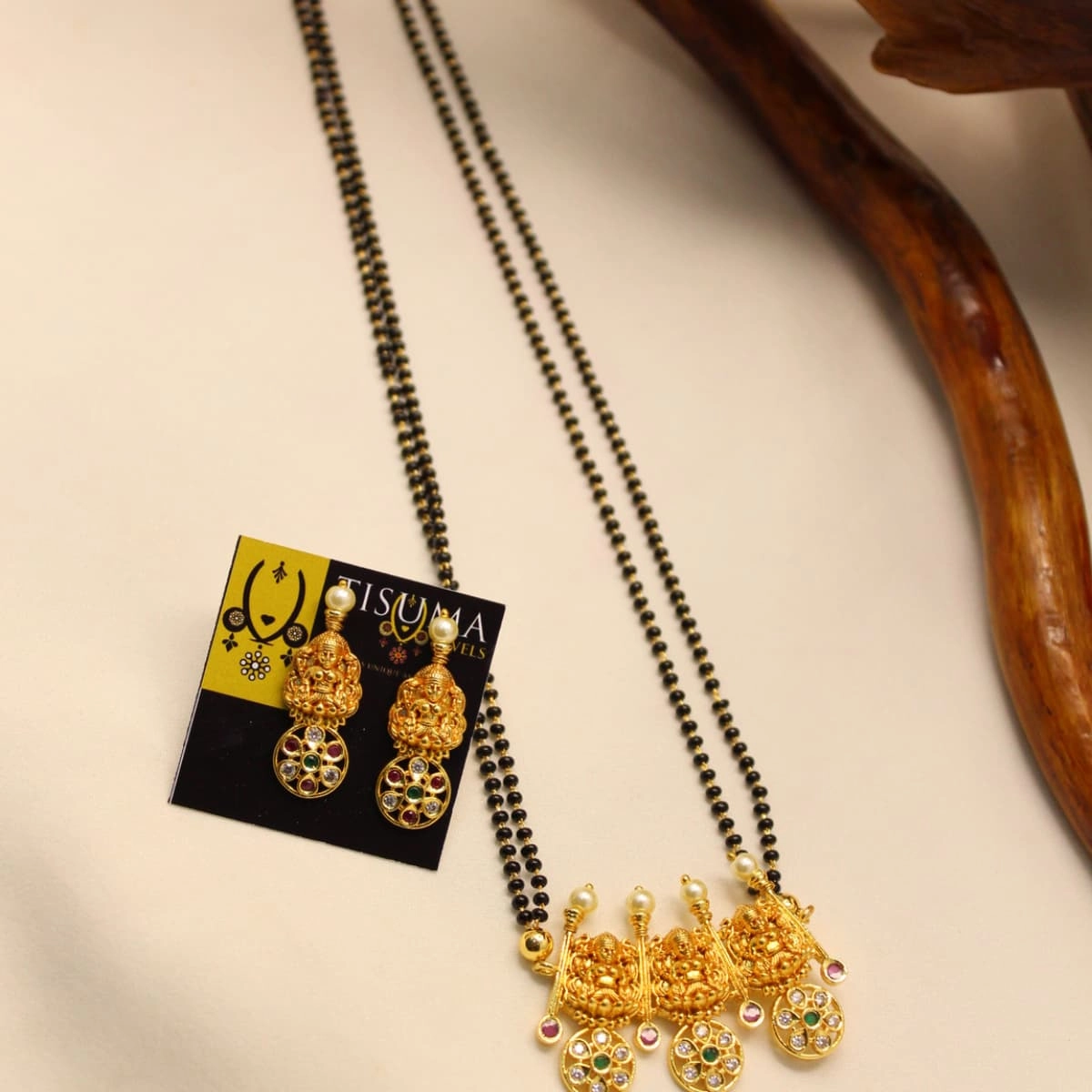 Double-line black beads mangal sutra with three antique Lakshmi pendants and multicolour stones