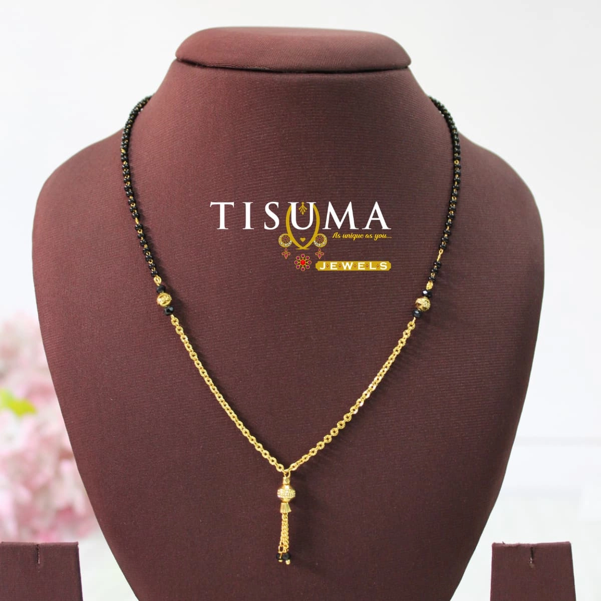 Gold-tone black bead mangalsutra with decorative chain and centre tassel drop