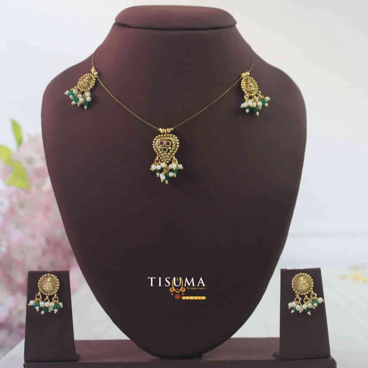 Gold finish invisible chain set with green and purple stones, pearl-style drops and matching earrings