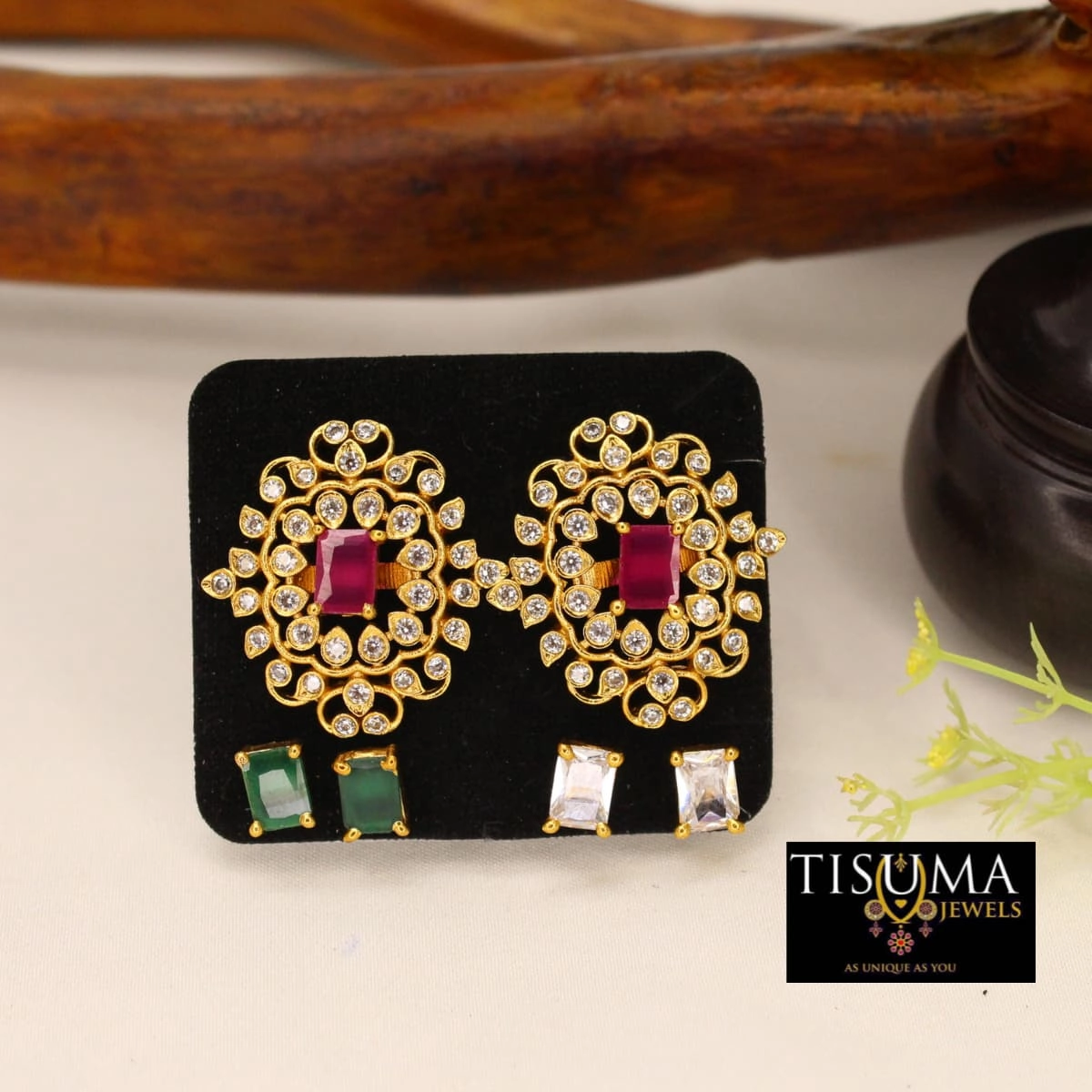 Ruby red centre stone floral AD stud earrings with clear stones and gold-tone finish