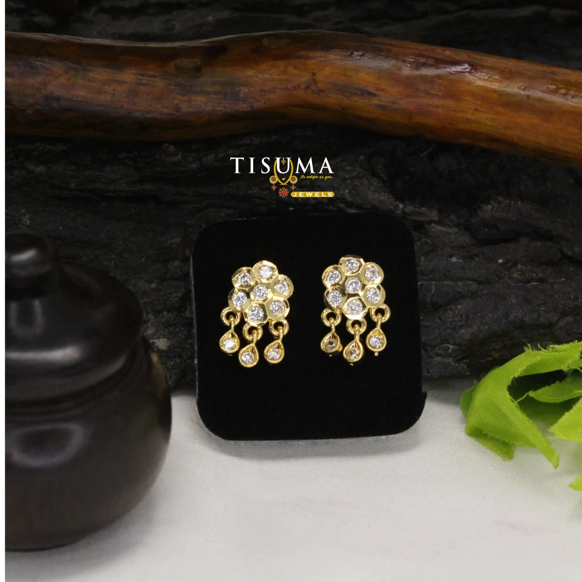 Gold-tone floral AD stud earrings with clear stones and three dangling drops