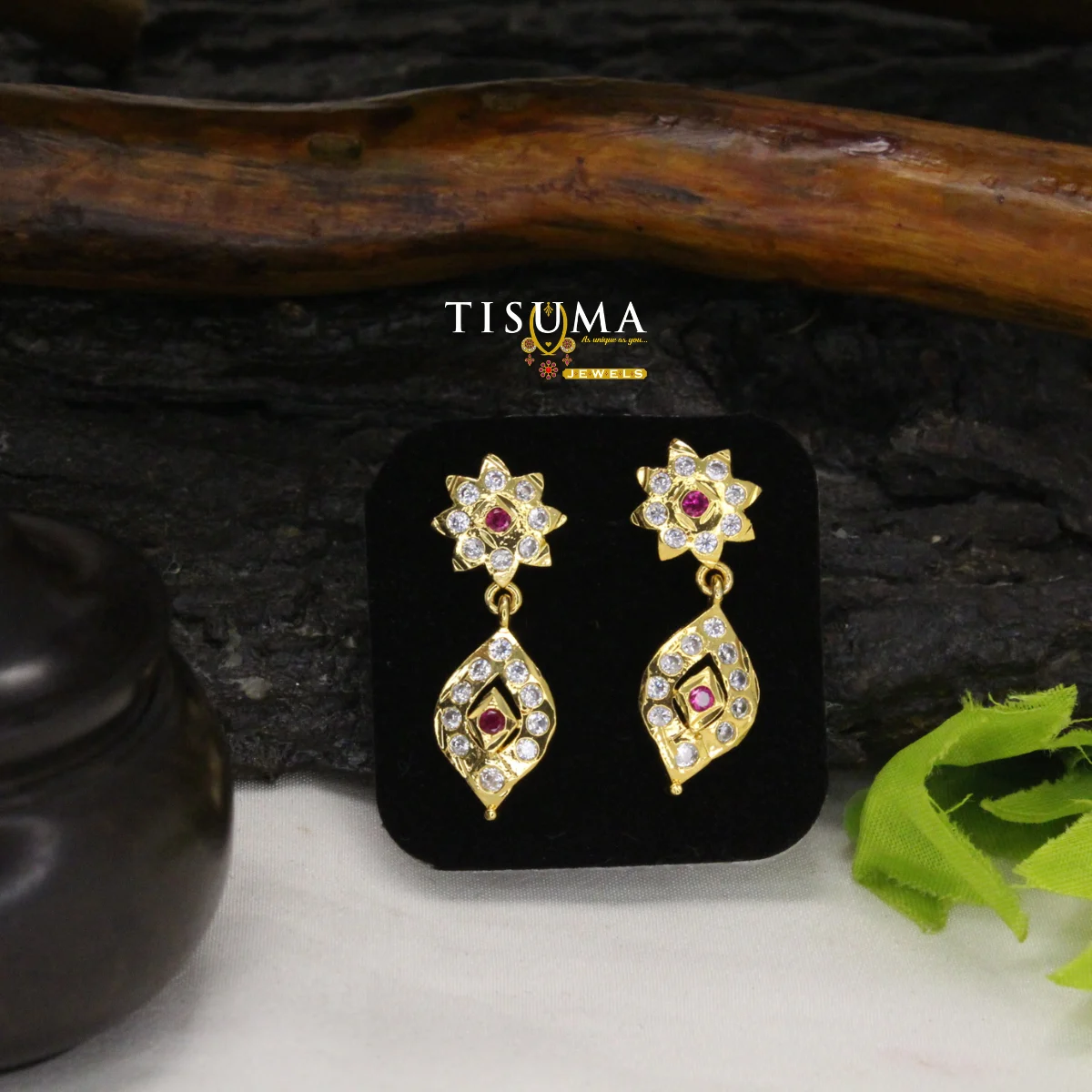 Gold-tone floral drop earrings with ruby-red stones and leaf-shaped white stone design
