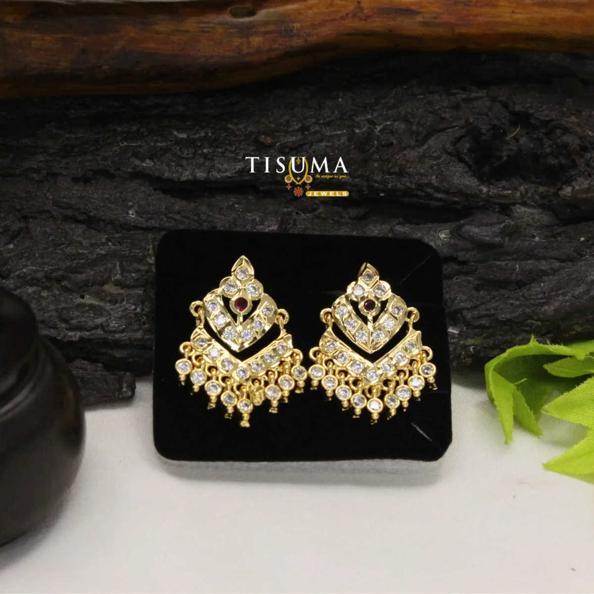 Gold-tone geometric chandbali earrings with ruby-red centre stones and white stone detailing