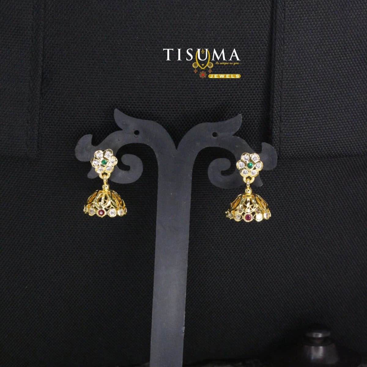 Gold-tone floral jhumka earrings with green centre stones and ruby-red accents