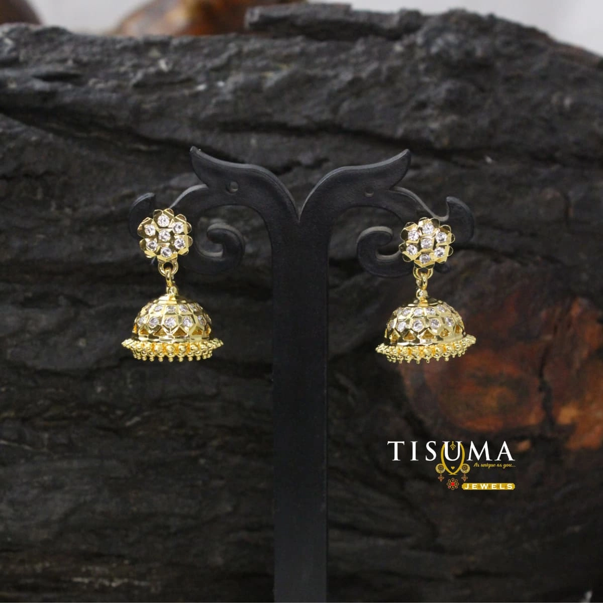 Gold-tone floral jhumka earrings with white AD-style stones and decorative beaded border