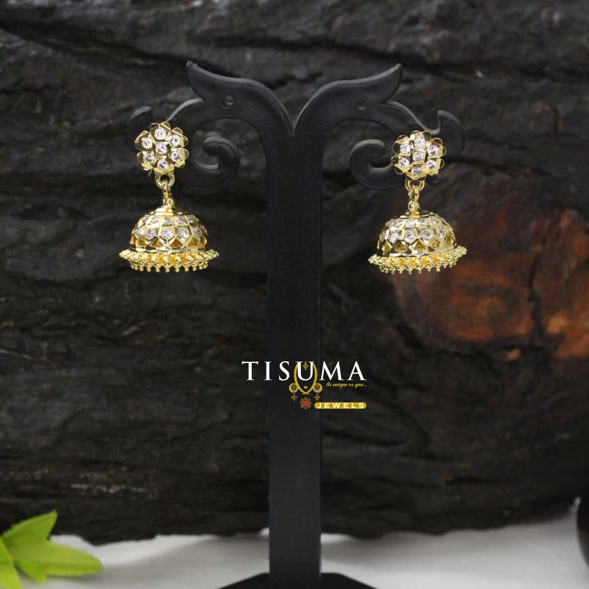 Gold-tone floral jhumka earrings with white AD-style stones and decorative beaded border
