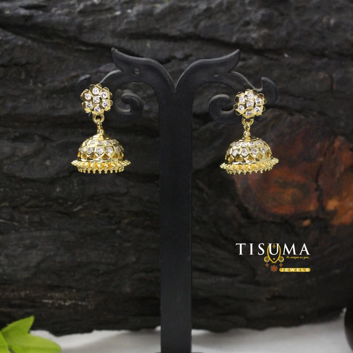 Gold-tone floral jhumka earrings with white AD-style stones and decorative dome