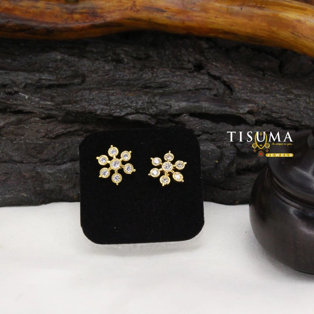 Gold-tone floral stud earrings with sparkling white stones