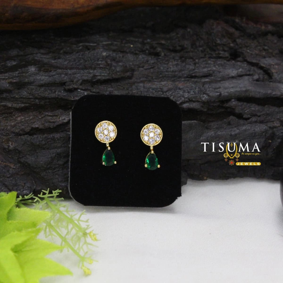 Gold-tone earrings with round white stone studs and green teardrop drops