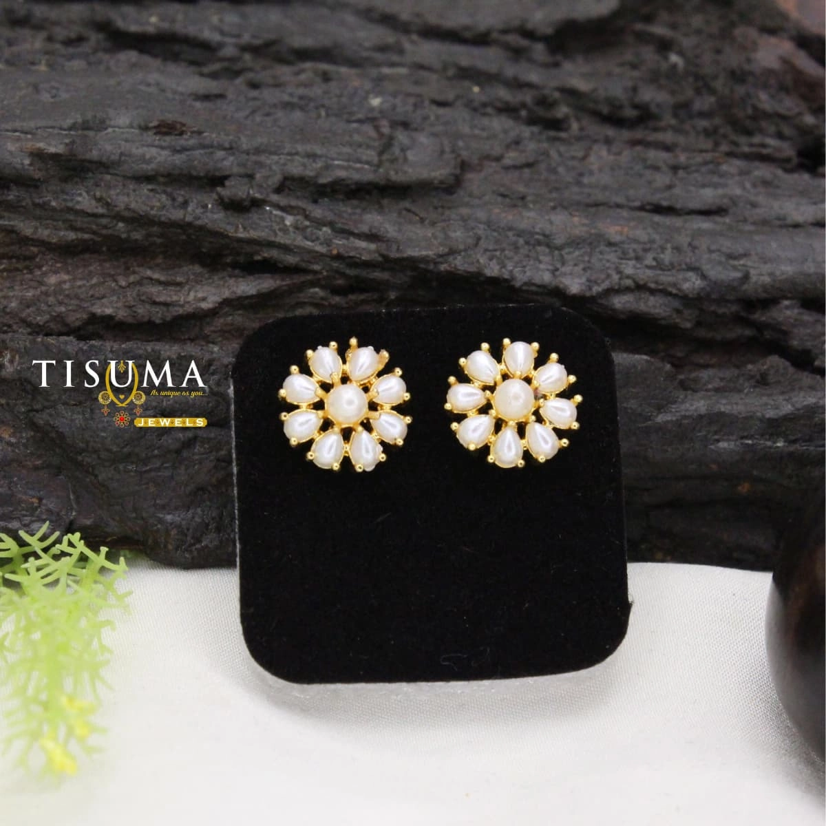 Gold-tone floral stud earrings with a round white pearl-style centre and teardrop-shaped white accents