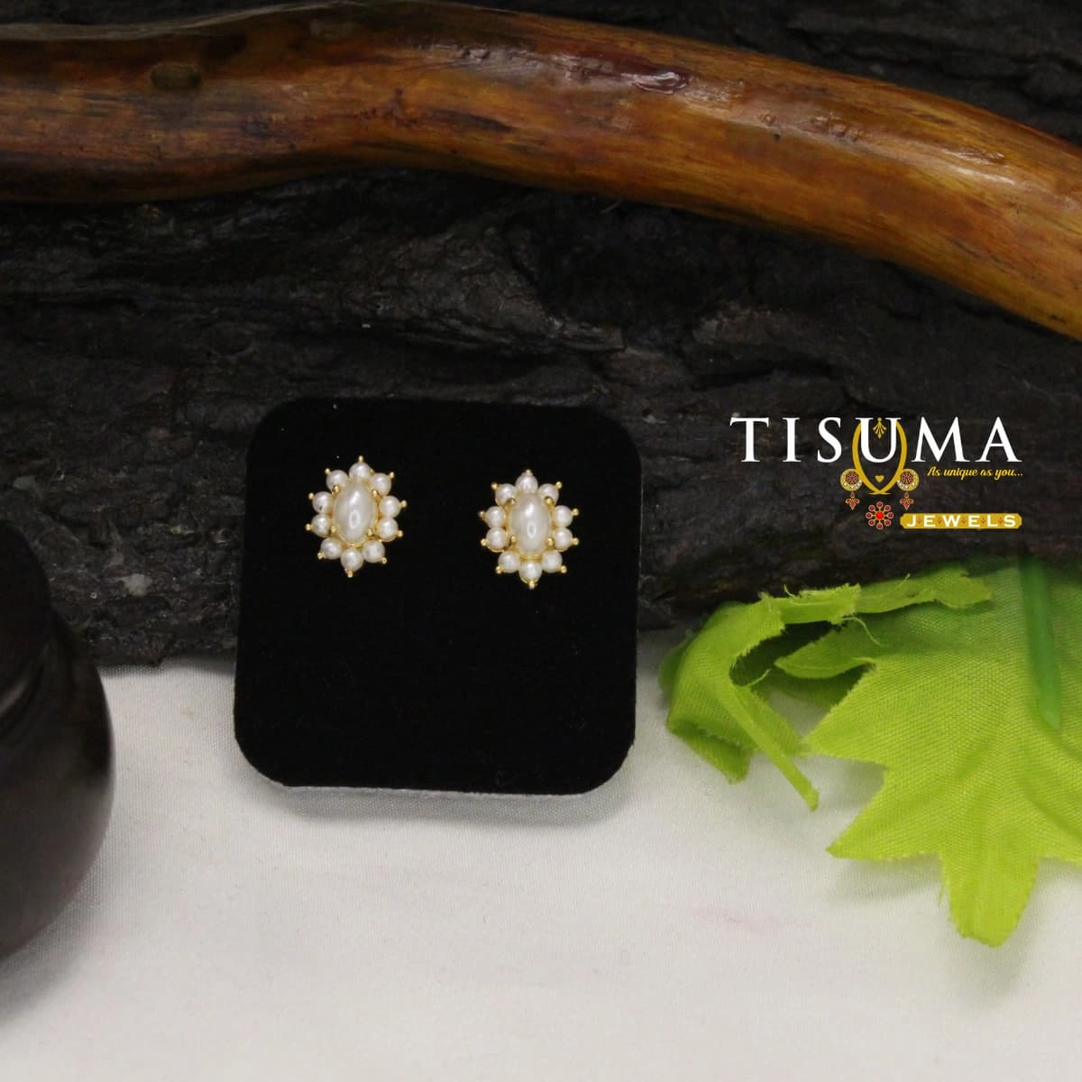 White oval pearl-look stud earrings with small pearl accents and gold-tone detailing