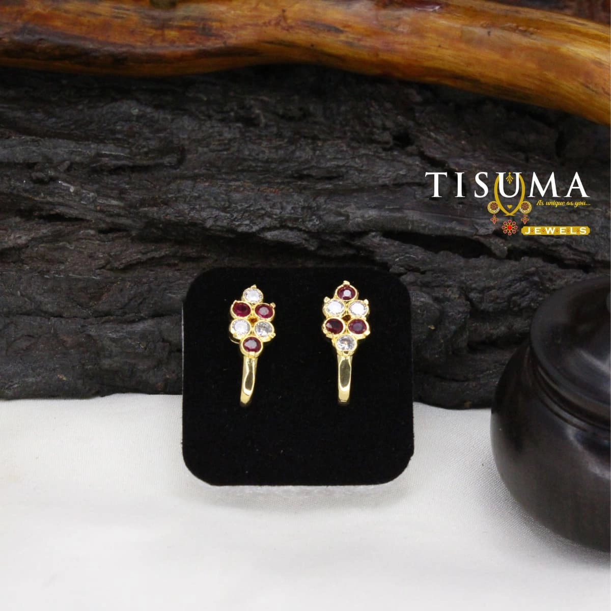 Gold-tone stud earrings with ruby red and white AD-style stones in a geometric cluster design