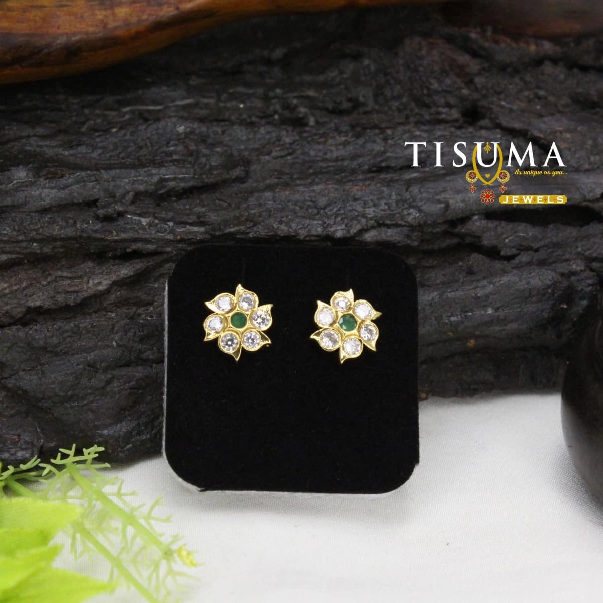 Gold-tone floral stud earrings with green centre stones and white AD-style stones