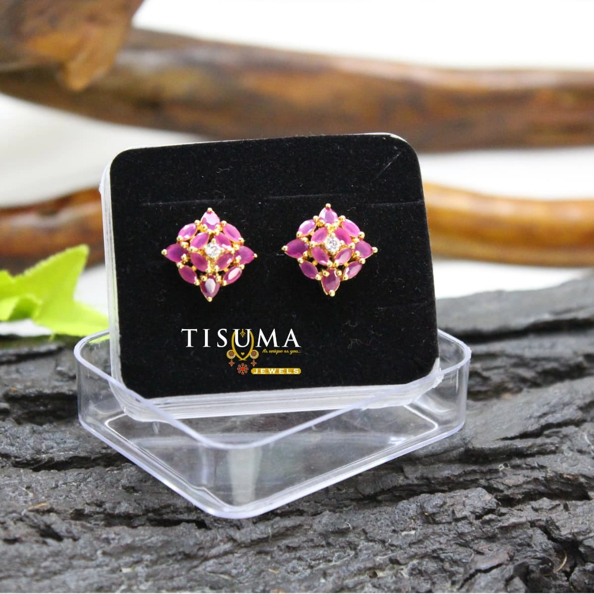 Gold-tone floral stud earrings with pink petal-shaped stones and sparkling white centre accents