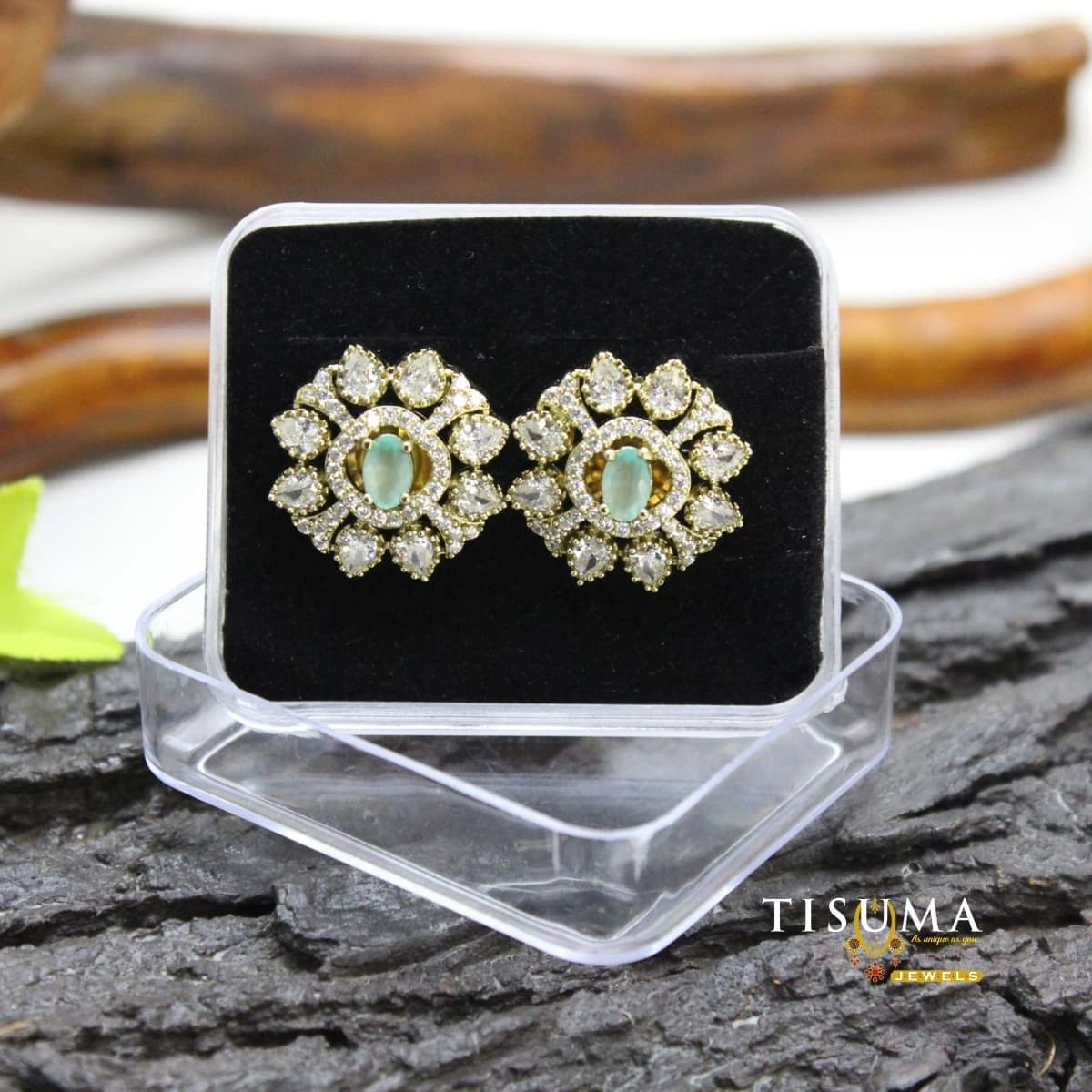 Green oval stone floral stud earrings with sparkling white stones and a gold-tone setting
