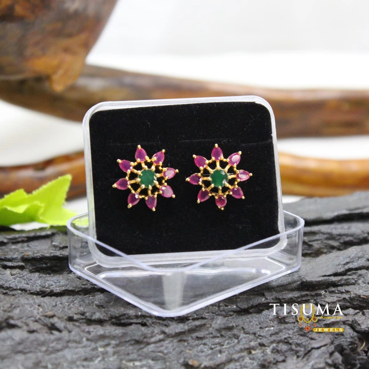 Pink petal-shaped and green centre stone floral stud earrings in a gold-tone setting