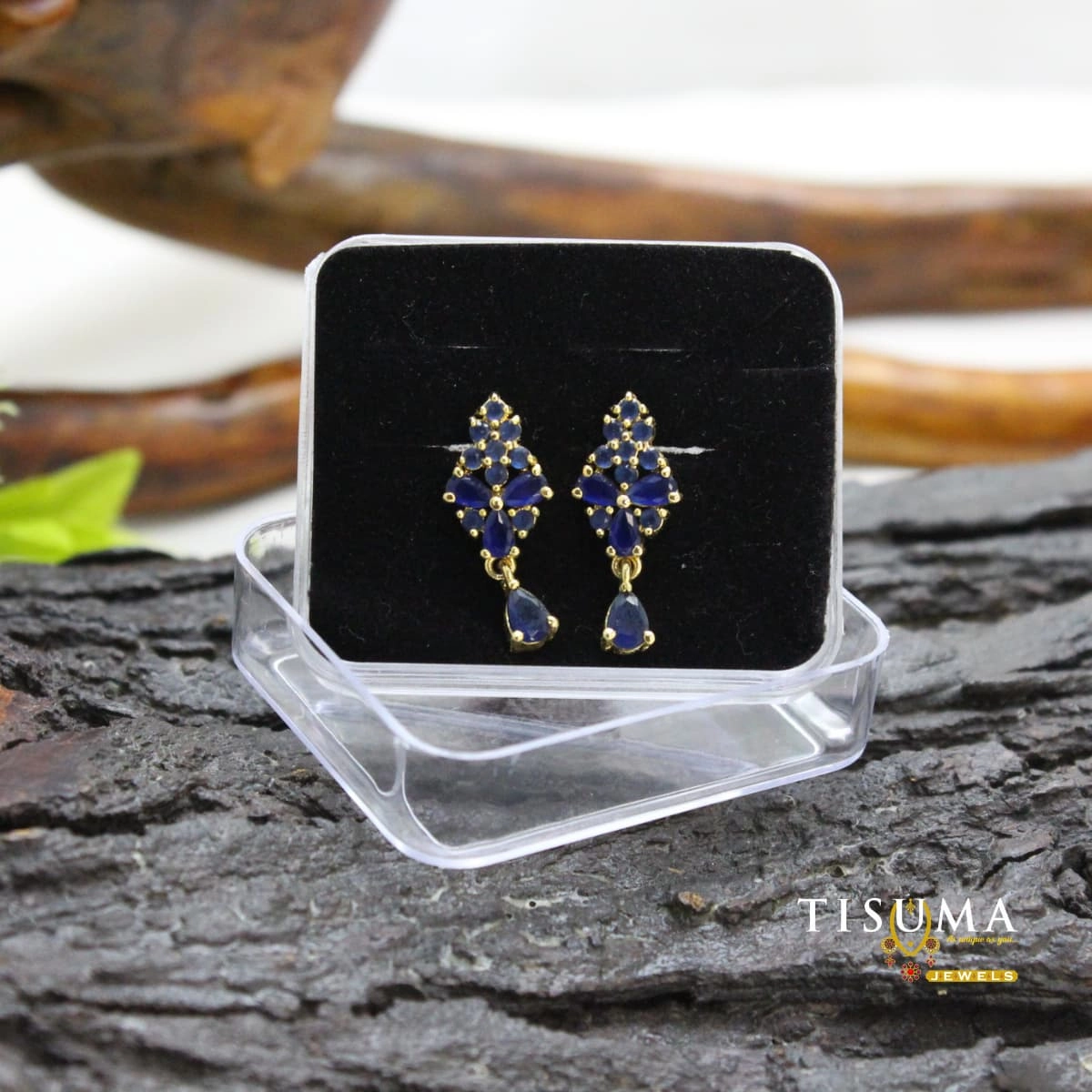Blue geometric drop earrings with gold-tone detailing and matching blue teardrop stones