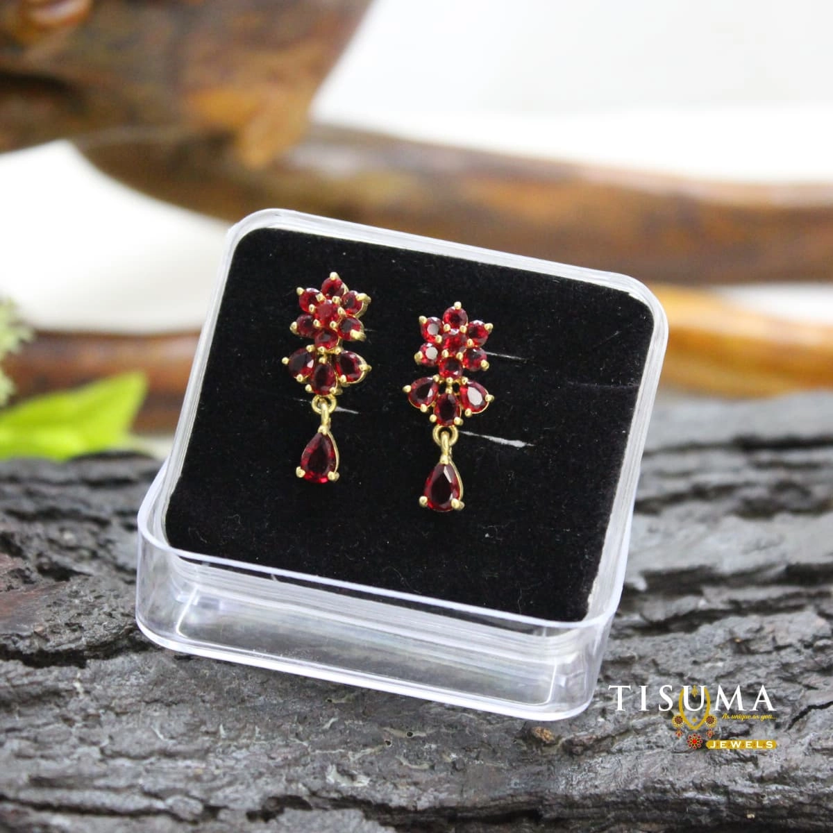 Ruby red floral drop earrings with gold-tone detailing and matching red teardrop stones