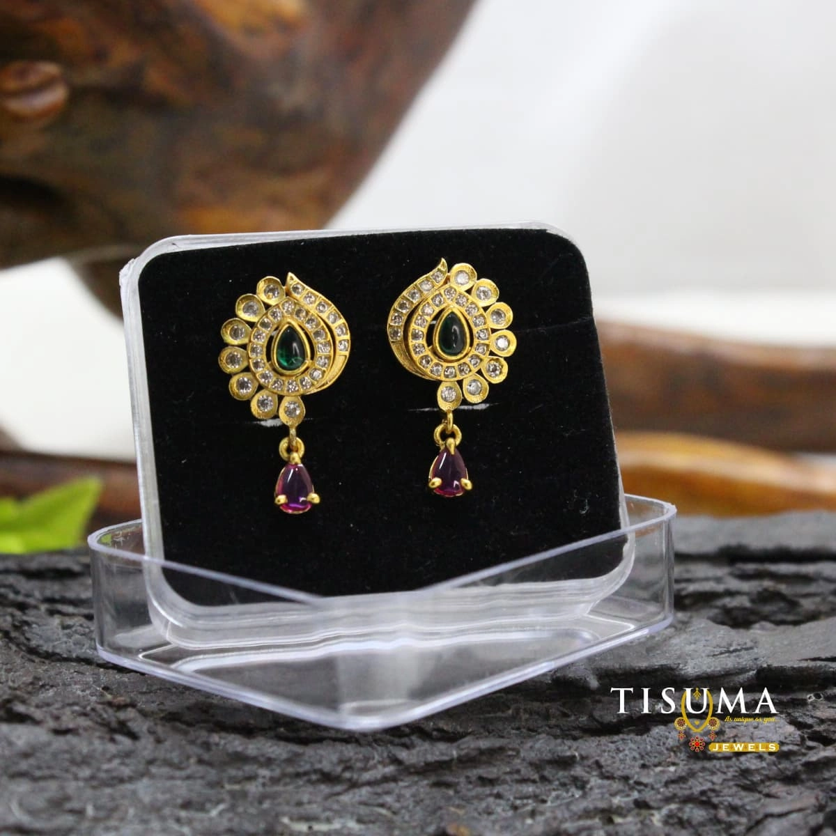 Gold-tone drop earrings with green teardrop centre stones, clear AD-style accents and purple dangling stones