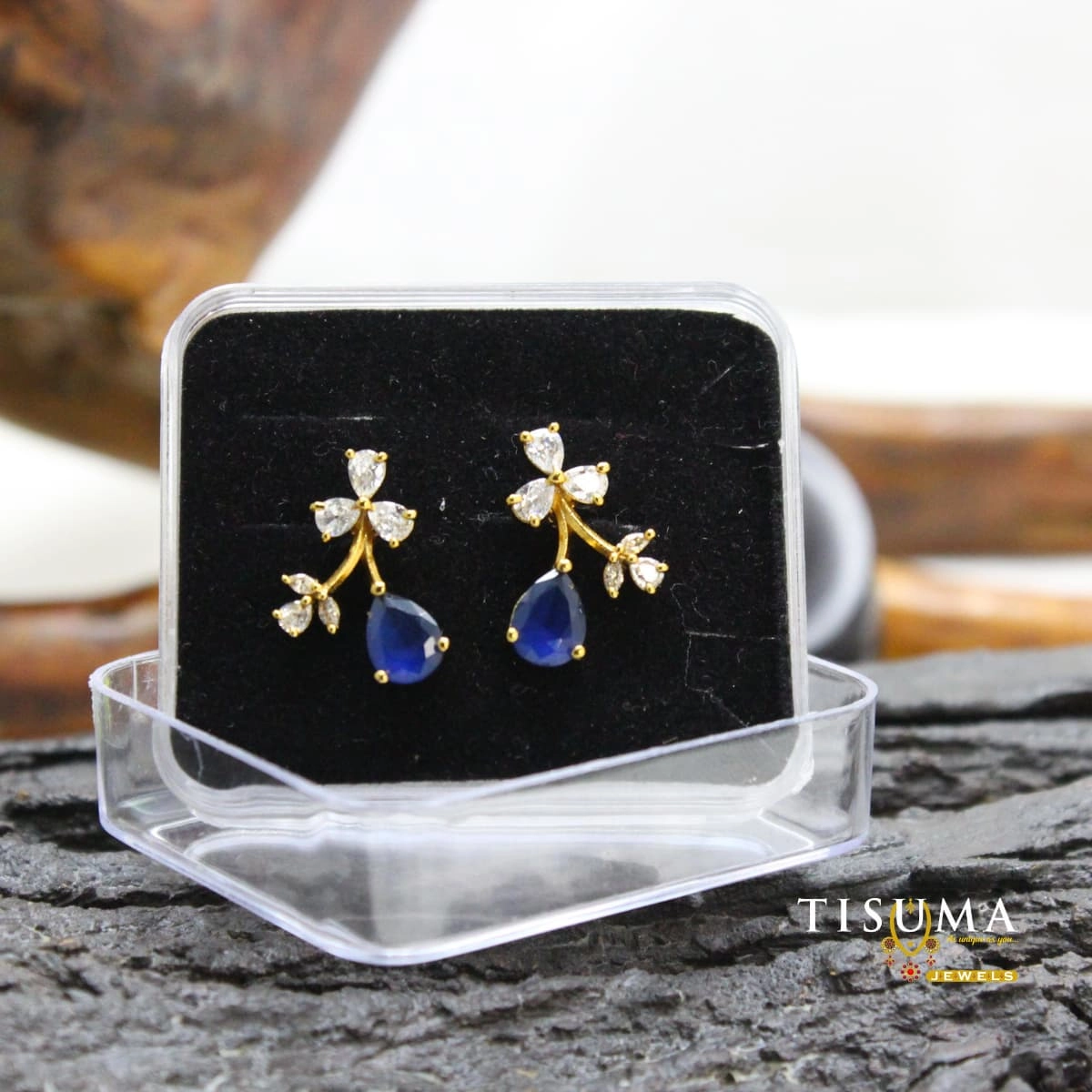 Gold-tone floral branch earrings with blue teardrop stones and clear AD-style accents