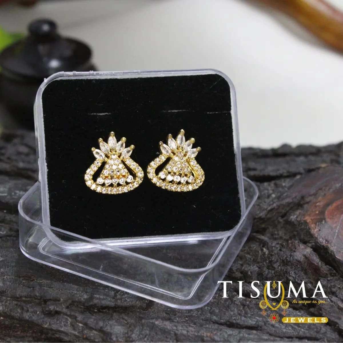 Gold-tone floral stud earrings with clear AD-style stones and curved design