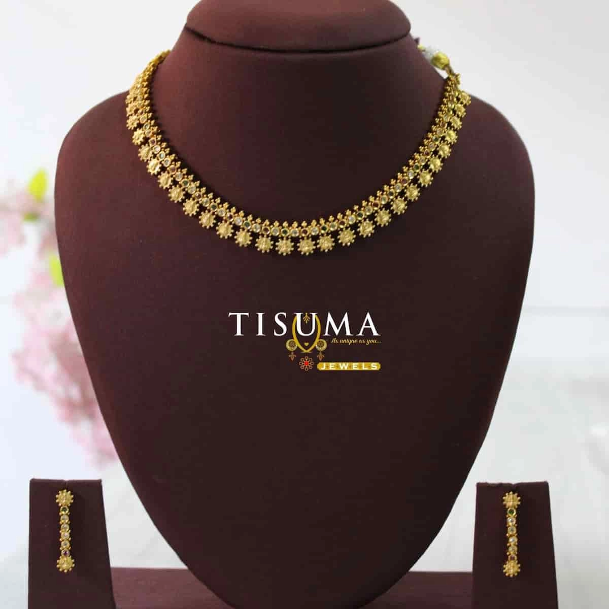 Antique gold finish matte necklace with intricate floral drop detailing, small decorative stones, and matching long earrings | Tisuma Jewels