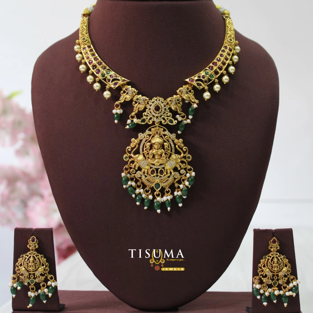 Traditional antique gold finish Lakshmi necklace with green and ruby stones, pearl drops, large goddess pendant and matching earrings – Tisuma Jewels.