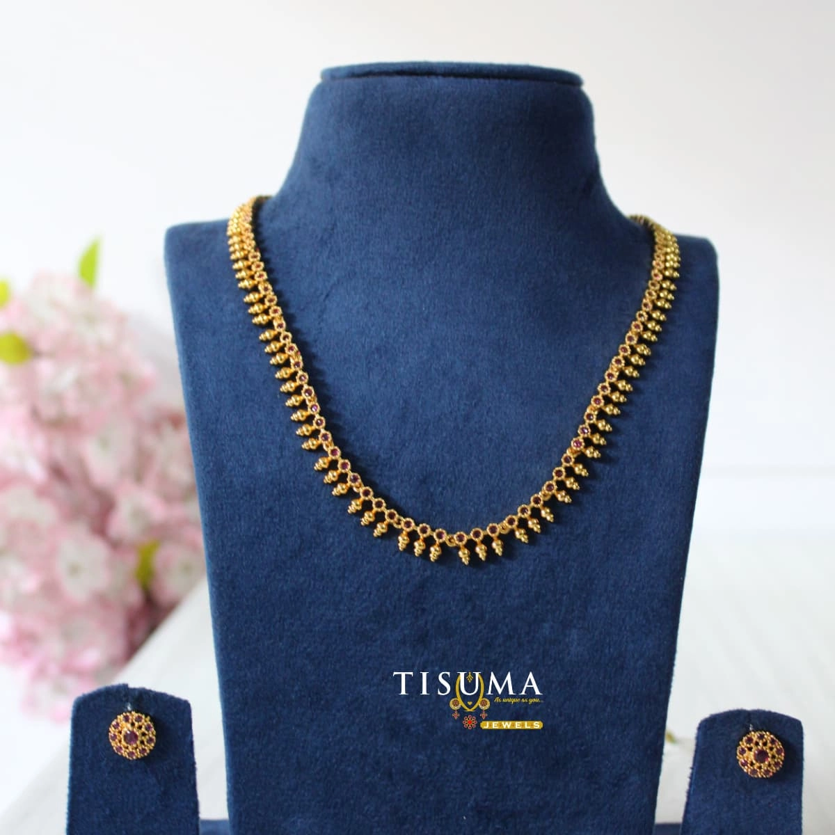 Ruby stone floral matte gold finish necklace with a delicate traditional design and matching stud earrings – Tisuma Jewels.