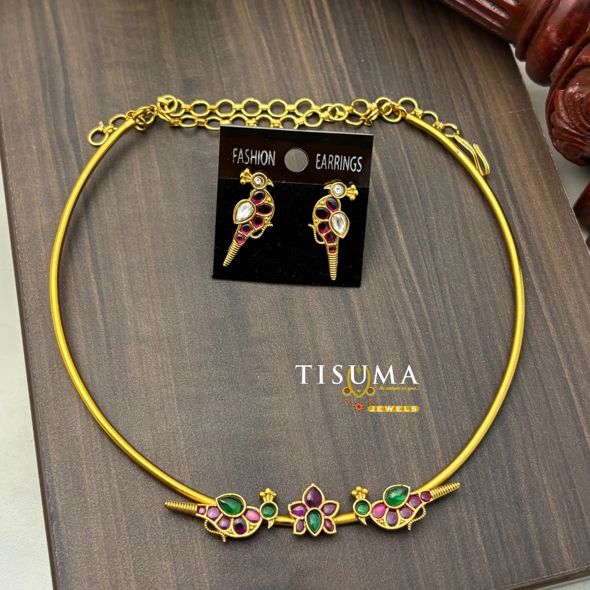 Gold finish necklace with pink and green floral stone designs and matching ruby pink and white stone earrings by Tisuma Jewels.