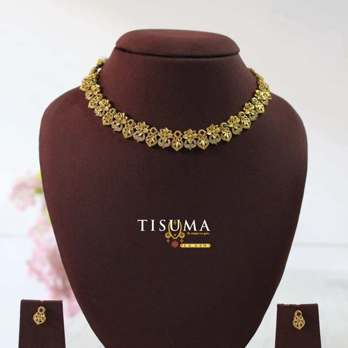 Gold-finish floral necklace with green purple and white stone accents