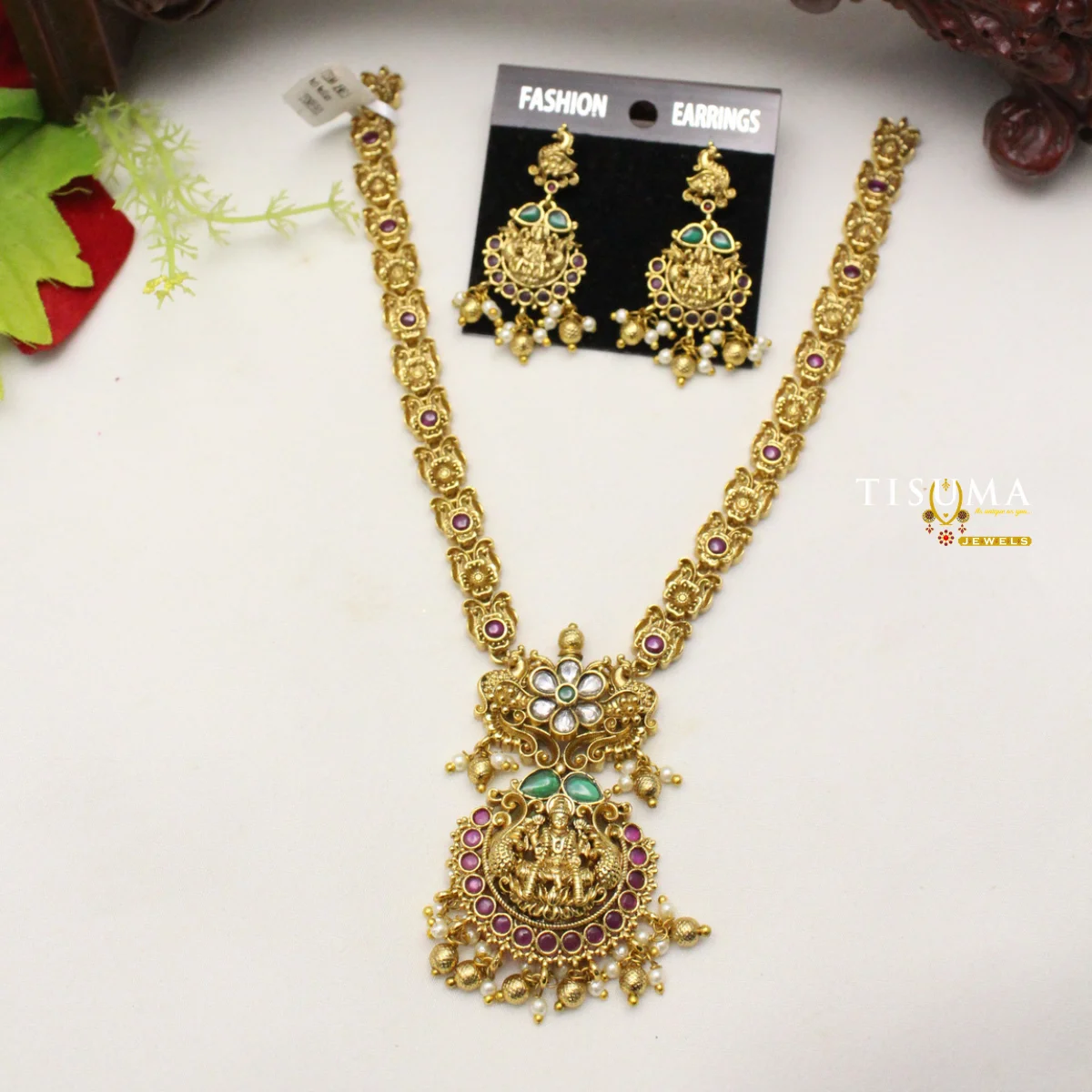 Antique gold-finish Lakshmi temple necklace set with ruby pink and green stones and matching earrings