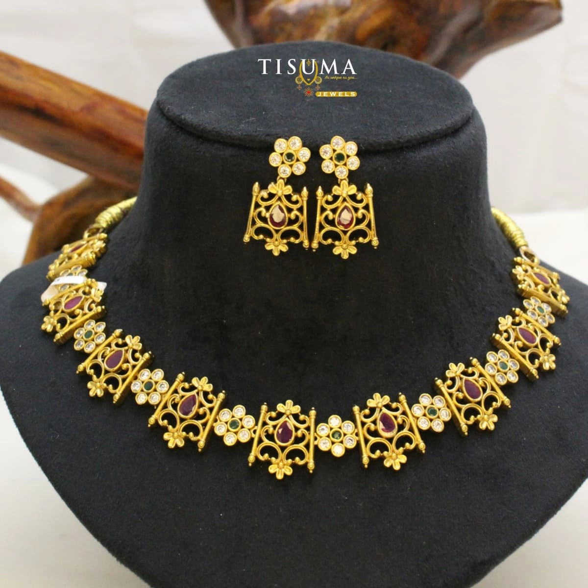 Antique gold-finish AD designer necklace set with ruby pink and green stones and matching earrings