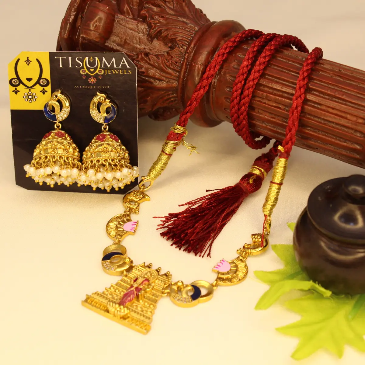 Traditional antique gold-finish temple pendant necklace with red braided thread and matching pearl-drop jhumka earrings