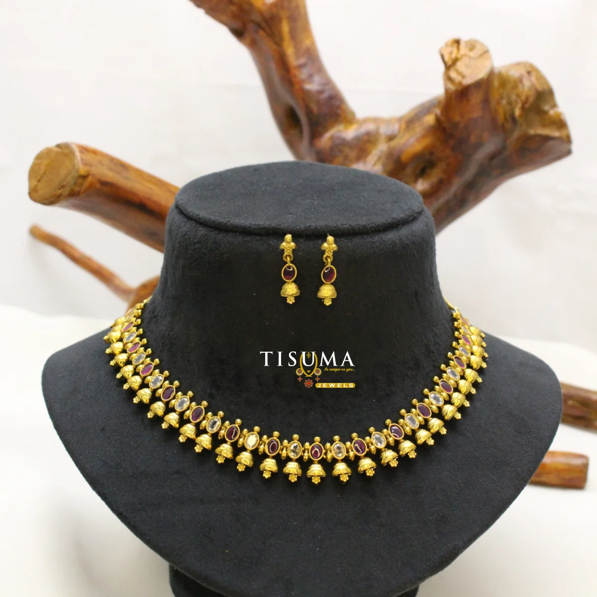 Traditional gold-tone necklace set with ruby red and white stones, decorative gold bead drops and matching earrings | Tisuma Jewels