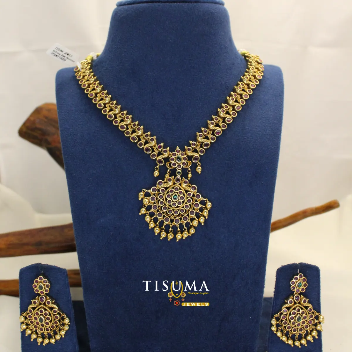 Traditional antique gold-tone necklace set with ruby and green stones, circular floral pendant and matching earrings | Tisuma Jewels