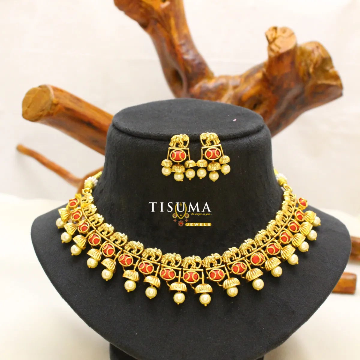 Traditional antique gold-tone necklace set with red stone accents, elephant motifs, cream pearl drops and matching earrings | Tisuma Jewels