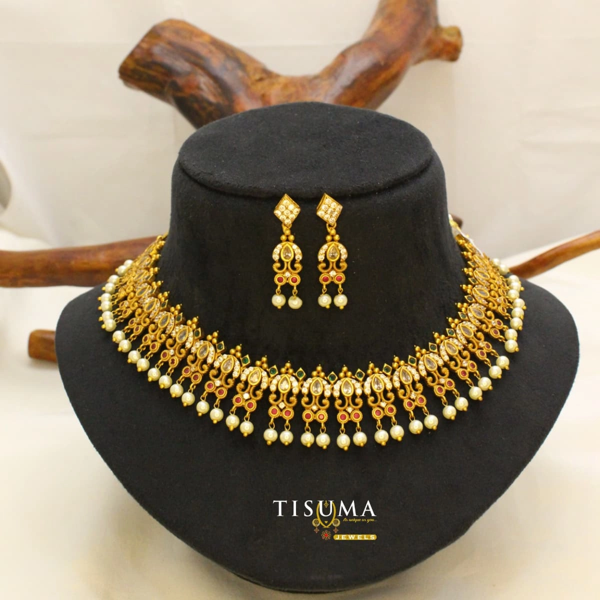 Traditional antique gold-tone matte necklace set with AD-style stones, ruby and green accents, pearl drops and matching earrings | Tisuma Jewels