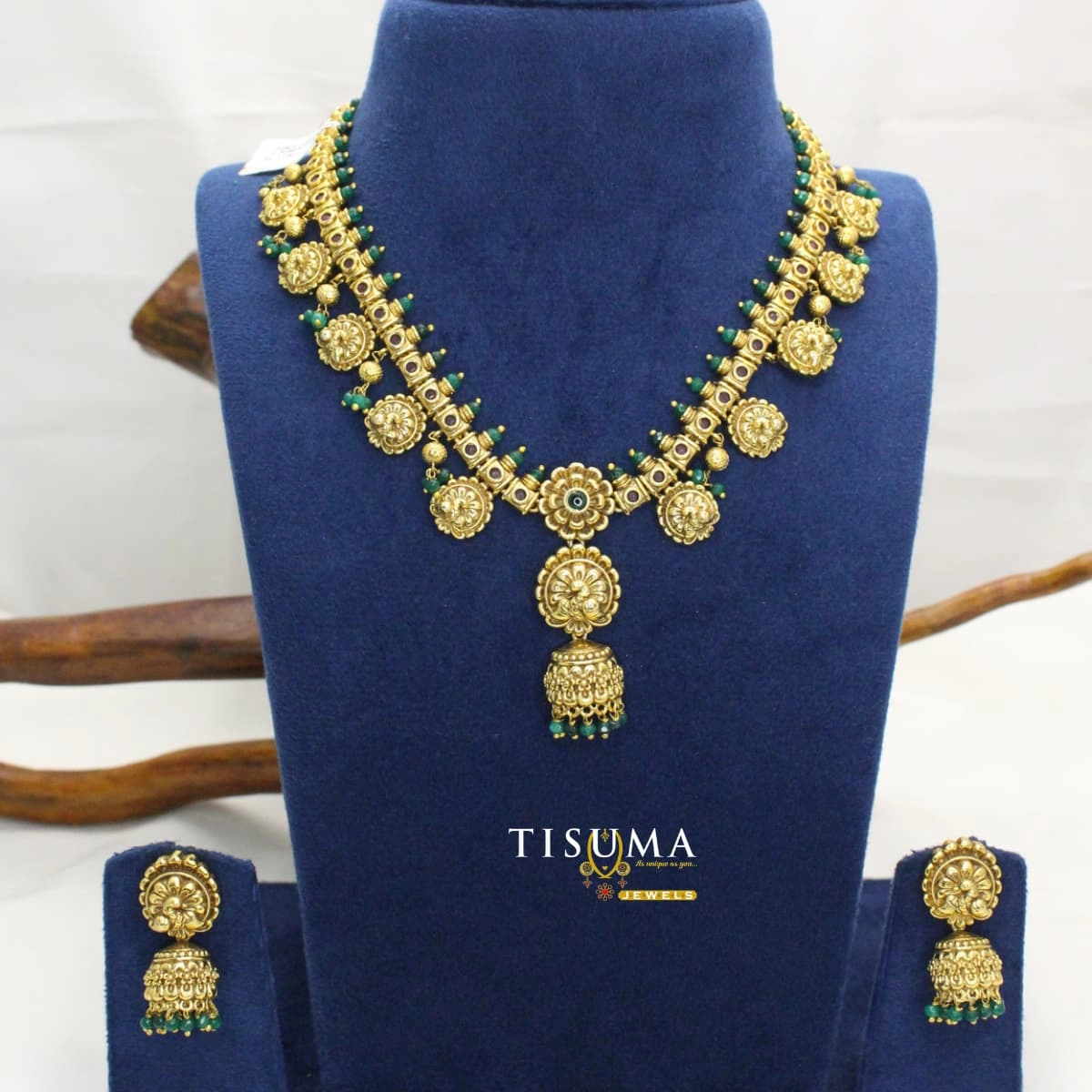 Antique gold-tone floral necklace set with round pendant, green bead drops and matching jhumka-style earrings | Tisuma Jewels